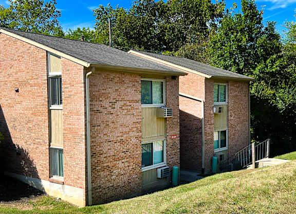 A brick building with a green lawn in front.