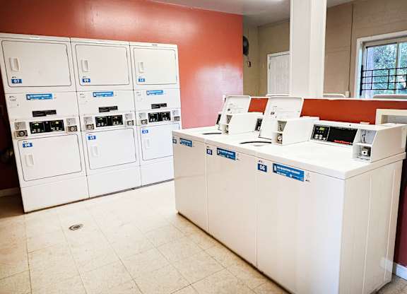 A bank with a white counter and a red wall.
