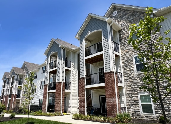 an apartment building with brick and white siding at Parkway Trails, Florence, KY, 41042