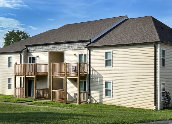 the exterior of a house with a balcony and a yard at 450 on Keeneland Apartments, Richmond