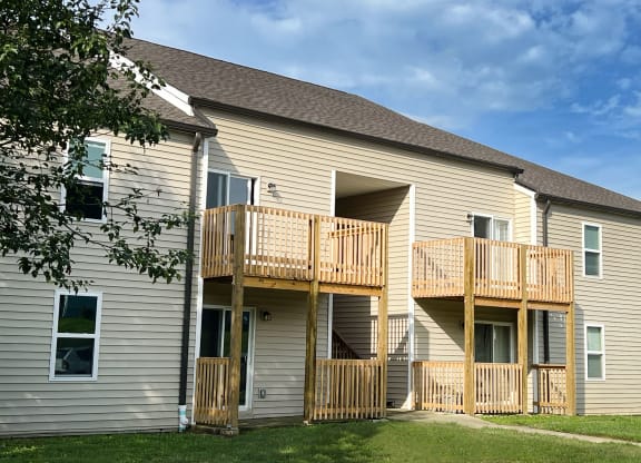 the back of a house with two balconies and a tree at 450 on Keeneland Apartments, Richmond, KY