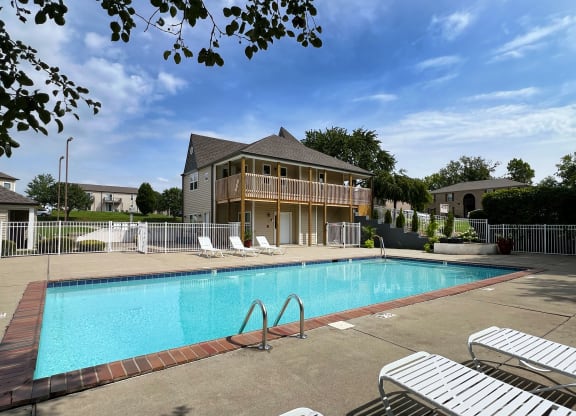 a swimming pool in front of a house at 450 on Keeneland Apartments, Richmond, KY