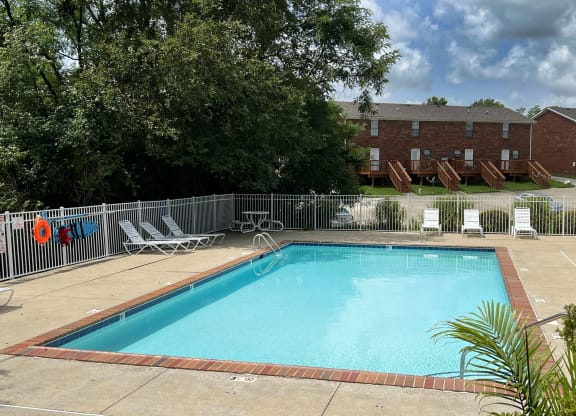 a swimming pool with chairs at 450 on Keeneland Apartments, Richmond