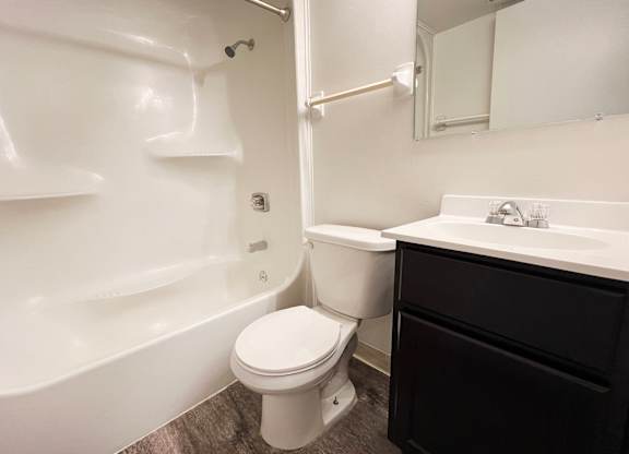 a bathroom with a toilet and a tub and a sink at Indian Lookout Apartments, Cincinnati
