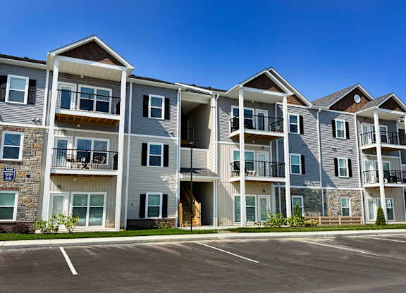 A large apartment complex with multiple balconies and doors.