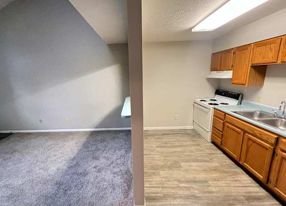 A split image of a kitchen and a living room.