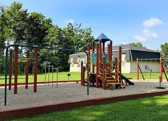 A playground with a swing set and a slide.