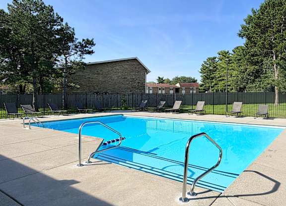 A small pool with a diving board in the foreground.