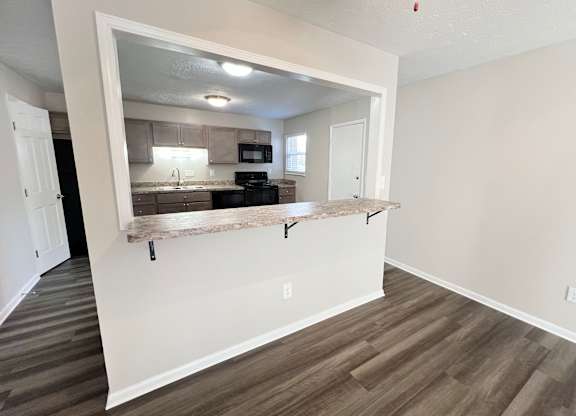 a view of a kitchen from a living room with a counter at Revere Village Apartments, Centerville, 45458
