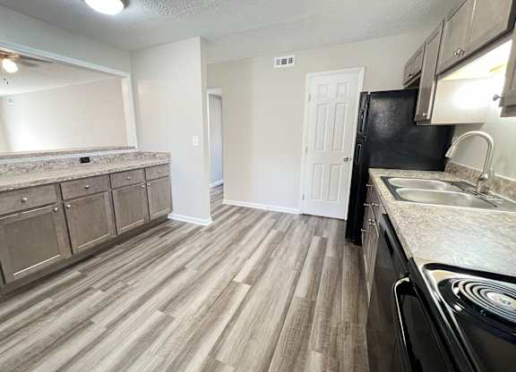 A kitchen with a black fridge and a sink at Revere Village Apartments, Ohio, 45458