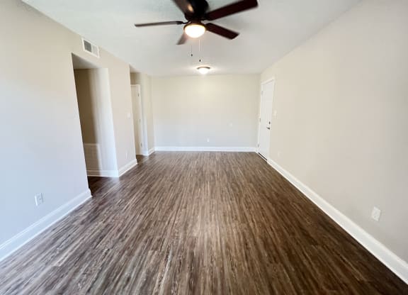 an empty living room with wood flooring and a ceiling fan at 450 on Keeneland Apartments, Kentucky, 40475