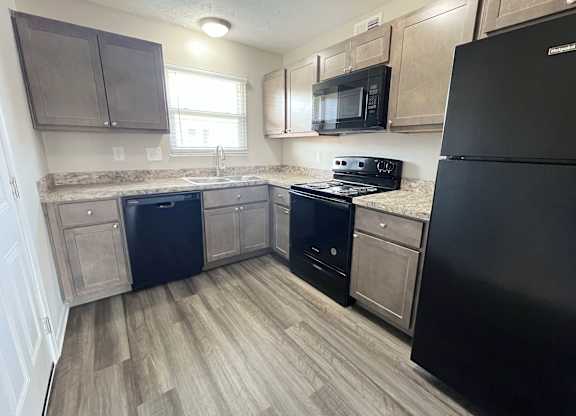a kitchen with wood flooring and stainless steel appliances at Revere Village Apartments, Centerville, 45458
