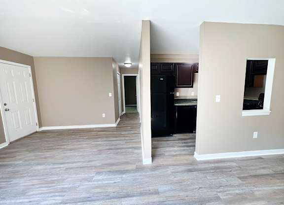 A room with a white door and a black cabinet.