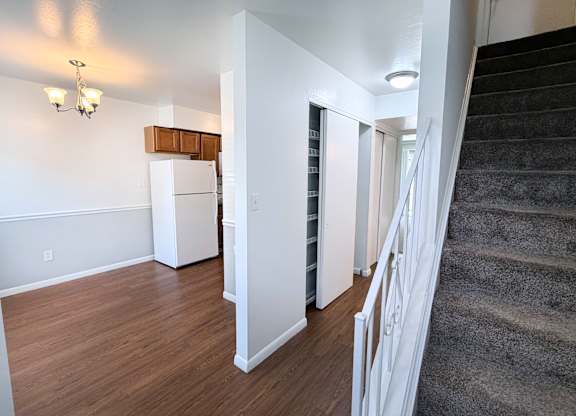 A staircase with a carpeted runner leads up to a second floor.