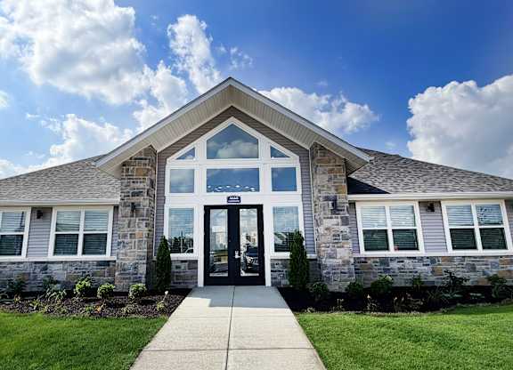 Clubhouse exterior with stone facade and entrance at The Meridian on 32 Apartments, Batavia, Ohio