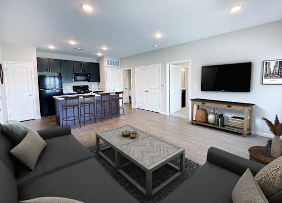 A modern living room with a grey couch and a coffee table.