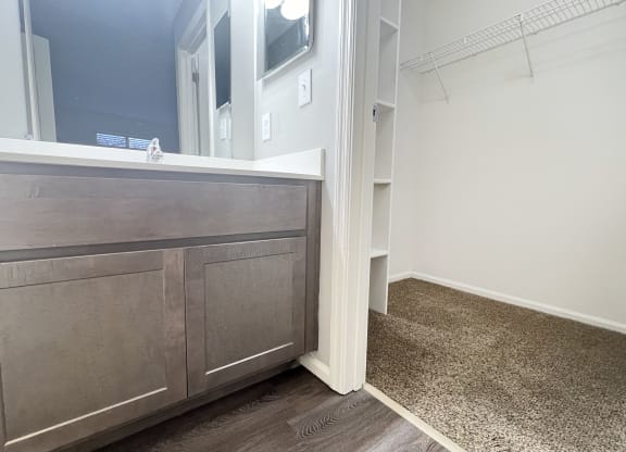 a bathroom with a vanity with a mirror and a sink  at Deercross Apartments, Cincinnati