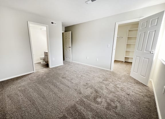 an empty living room with carpet and a closet  at Deercross Apartments, Cincinnati, 45236