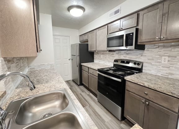 a kitchen with stainless steel appliances and granite counter tops  at Deercross Apartments, Cincinnati, OH, 45236