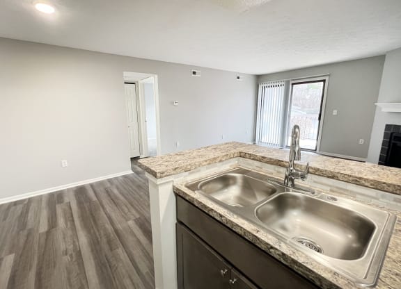 an empty kitchen with a sink and a window  at Deercross Apartments, Cincinnati, OH, 45236