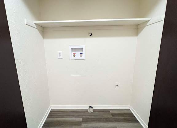 an empty room with a white wall and a door at Four Worlds Apartments, Cincinnati