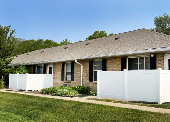 a house with a white fence in front of it  at Wyndemere Apartments, Ohio