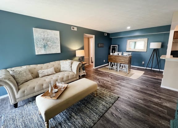 a living room with a couch and a coffee table  at Steeplechase Apartments, Loveland