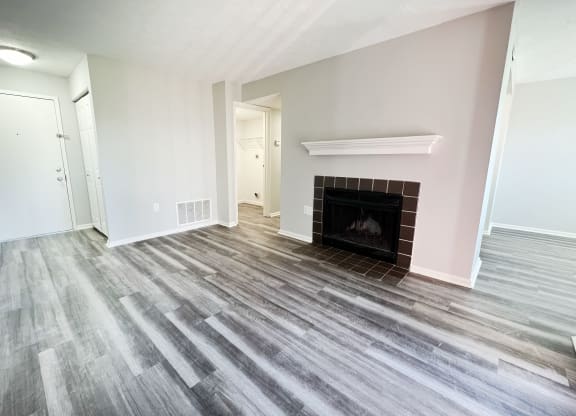a living room with wood flooring and a fireplace  at Deercross Apartments, Cincinnati, 45236
