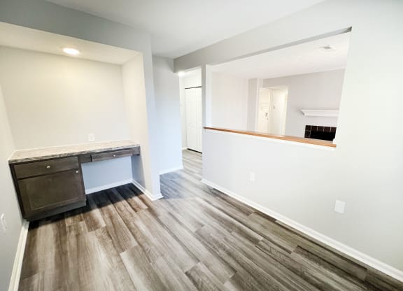an empty room with a desk and a mirror in a new home  at Deercross Apartments, Ohio