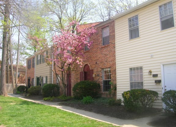 a side view of a house with a pink flowering tree at Walnut Creek Townhomes, Ohio