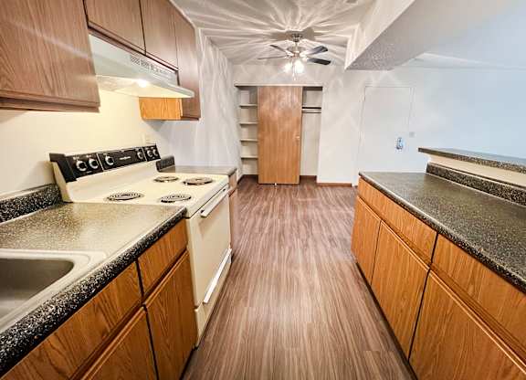 a kitchen with wood flooring and granite counter tops at Forest Creek Apartments, Middletown, Ohio 45044