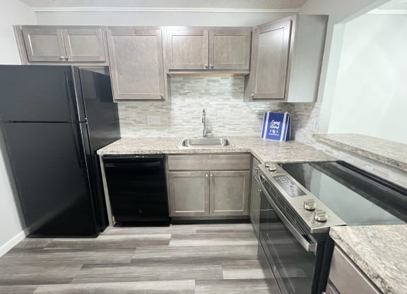 a kitchen with a black refrigerator and a counter top at Fox Run Apartments, Cincinnati, OH