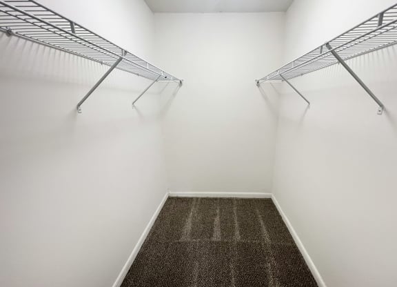 a room with two hanging racks on the wall and a carpet on the floor at Fox Run Apartments, Cincinnati, Ohio 45236