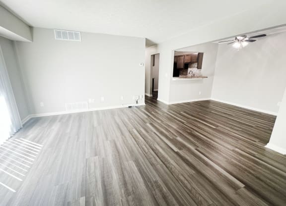 an empty living room with wood flooring in a new home at Fox Run Apartments, Cincinnati, OH