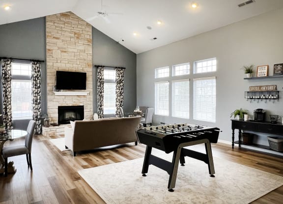 a game room with a foosball table and a couch