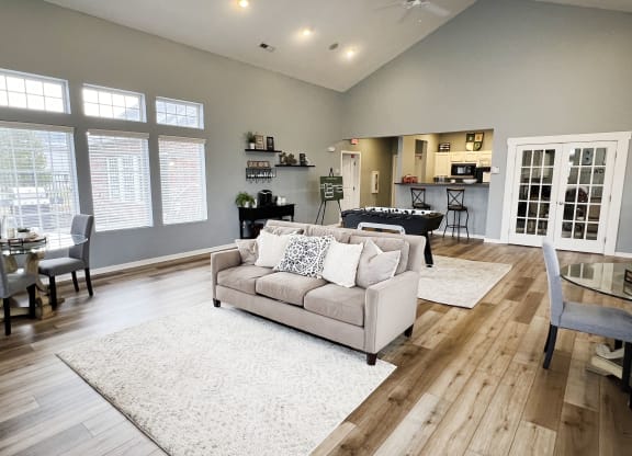 a living room with a couch and a table with chairs