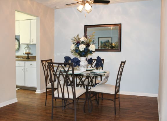 a dining room with a table and chairs and a ceiling fan  at Hunter's Creek Apartments, Ohio, 45242