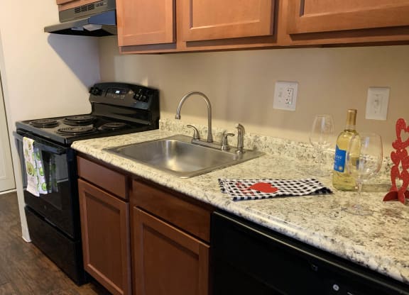 a kitchen with a sink and a stove and a counter top  at Timber Ridge Apartments, Ohio, 45241
