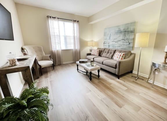 a living room with a couch and a table at Residences at Northgate Crossing, Ohio, 43235