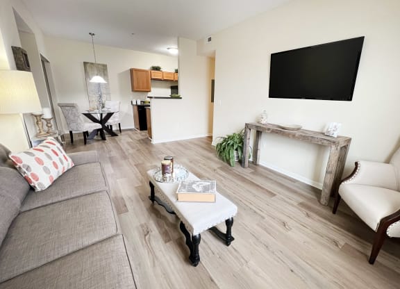 a living room with a couch and a table and a television at Residences at Northgate Crossing, Ohio, 43235
