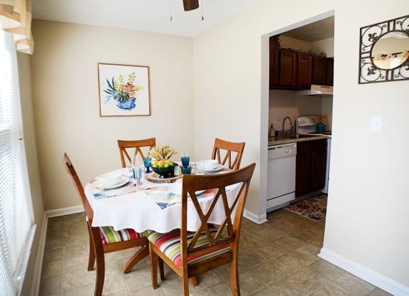 a dining room with a table and chairs and a kitchen at Timber Ridge Apartments, Cincinnati, OH, 45241
