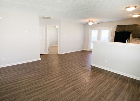 an empty living room with wood flooring in an apartment  at Aberdine Place, Georgetown