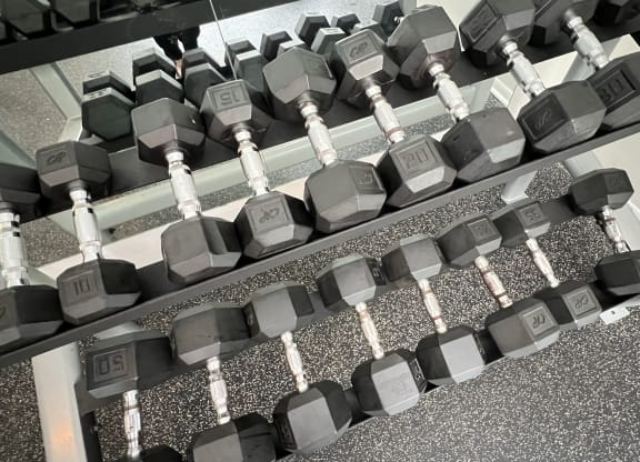 a row of dumbbells on the floor of a gym at The Vinings Apartments, Cincinnati, 45245