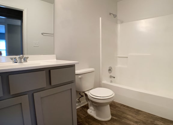an empty bathroom with a toilet and a sink at Knobs Pointe Apartments, New Albany