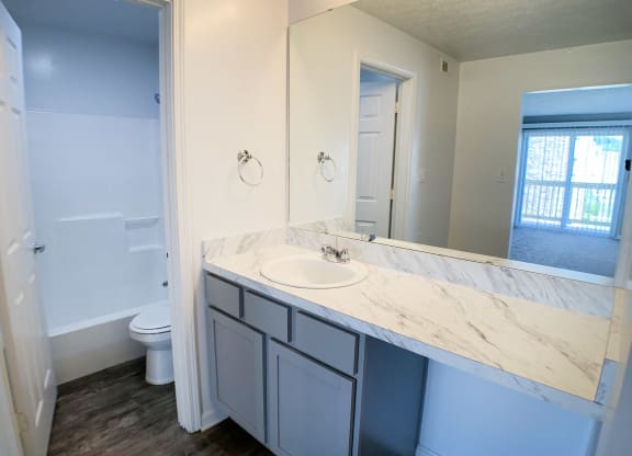 an empty bathroom with a sink and a toilet at Knobs Pointe Apartments, New Albany