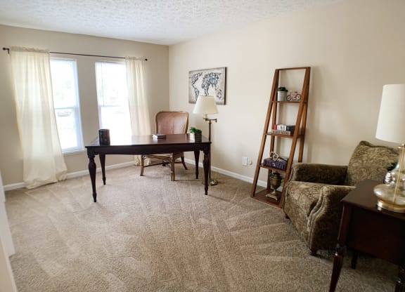 a living room with a desk and a couch  at Knobs Pointe Apartments, New Albany, IN, 47150