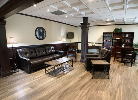 a living room with couches and chairs and a table  at Knobs Pointe Apartments, New Albany, Indiana