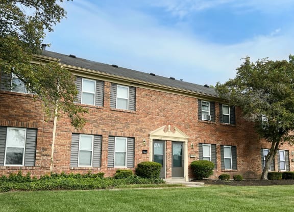 our apartments are located in a brick building with green grass and trees at Revere Village Apartments, Centerville