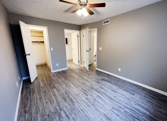 an empty living room with a ceiling fan at Quail Meadow Apartments, Ohio