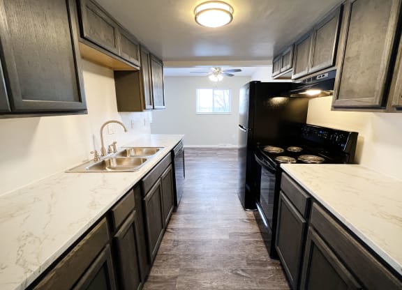 a kitchen with dark cabinets and white countertops at Wentworth Estates Apartments, Florence, KY